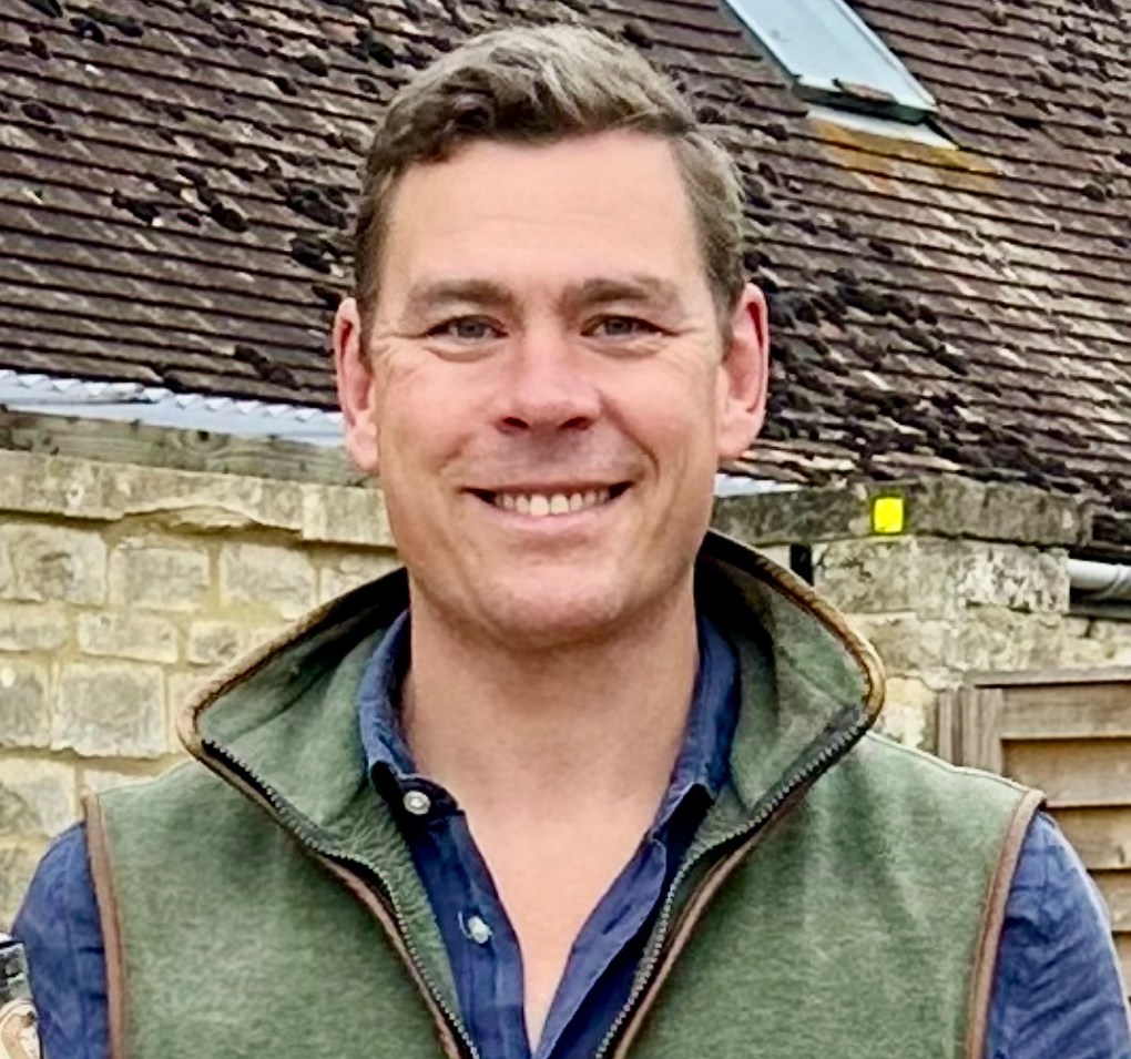 Angus Maclean holding a bottle of Copper Lion Dry Gin.